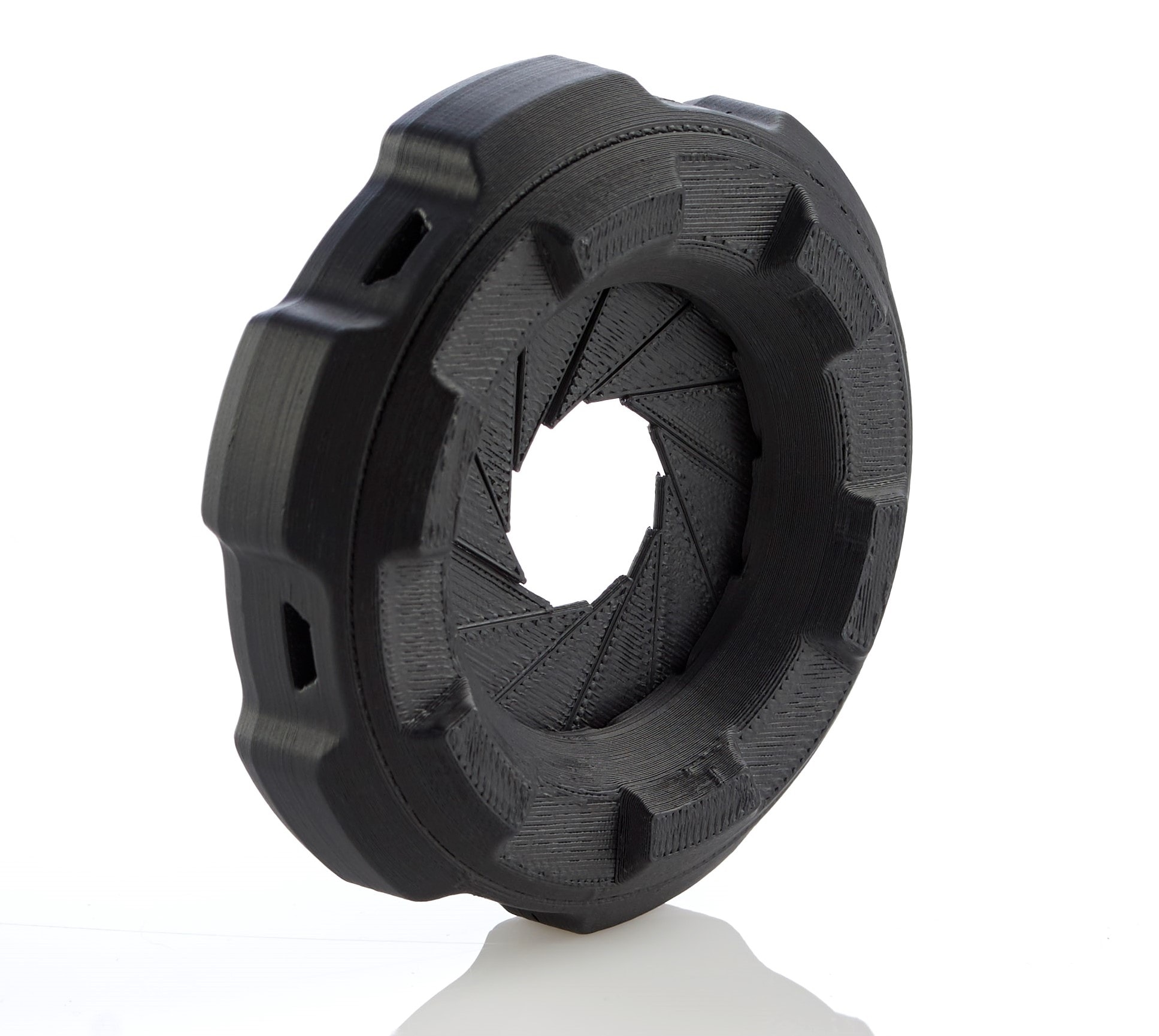 Stratasys FDM 3D printed camera lens-cover with integrated shutter-vanes. Printed in black ASA material. (Image courtesy Stratasys)