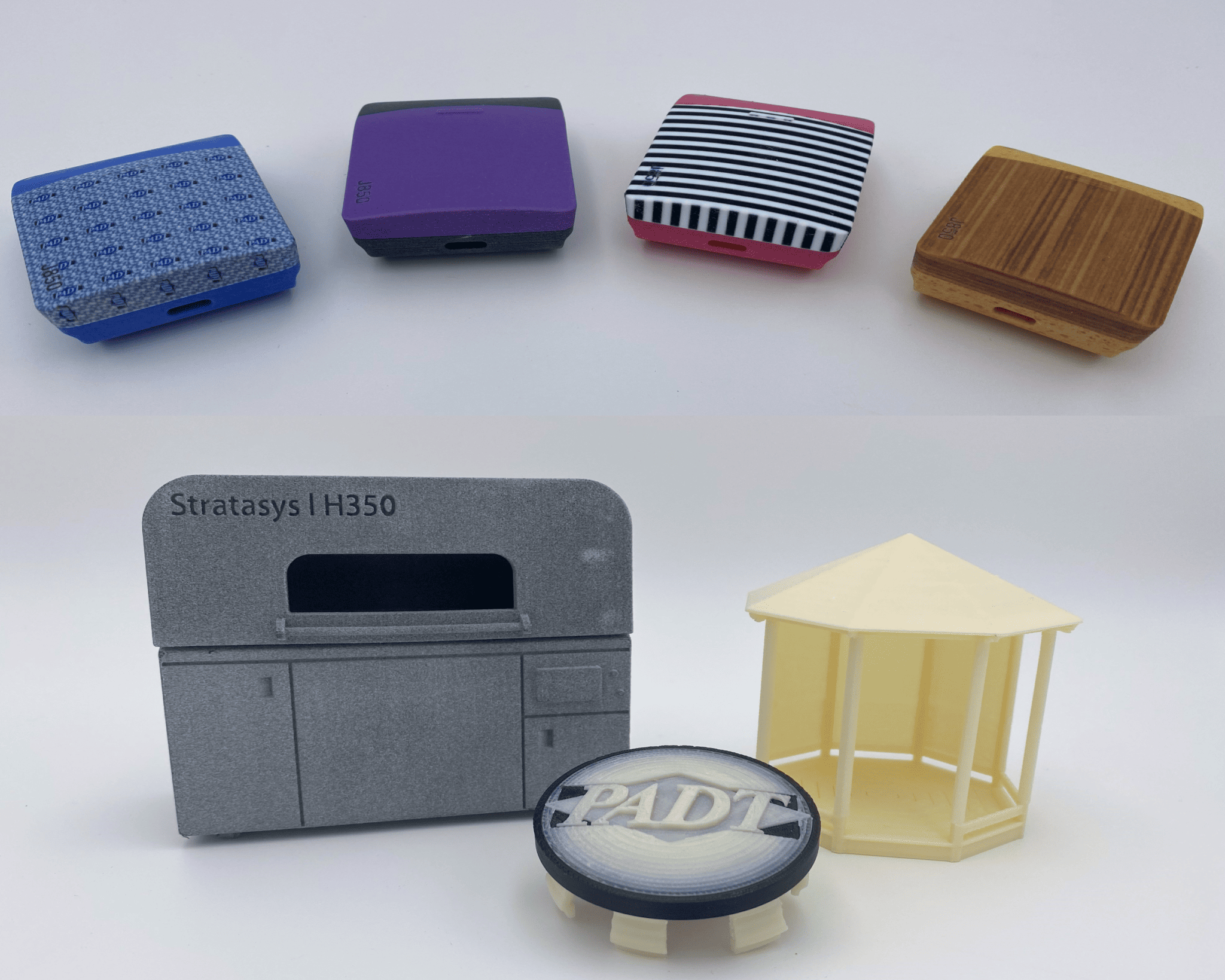 Photo showing seven 3D printed polymer parts that demonstrate Stratasys equipment capabilities for creating small, colorful and intricate models for marketing communications.